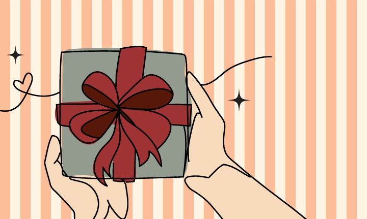 Hands holding a gift wrapped with a red bow